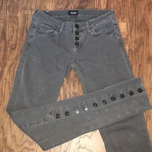 Grey Hudson jeans with black buttons.
